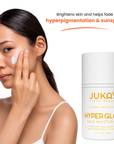 Woman applying JUKA'S Hyper Glow Face Moisturizer to her face