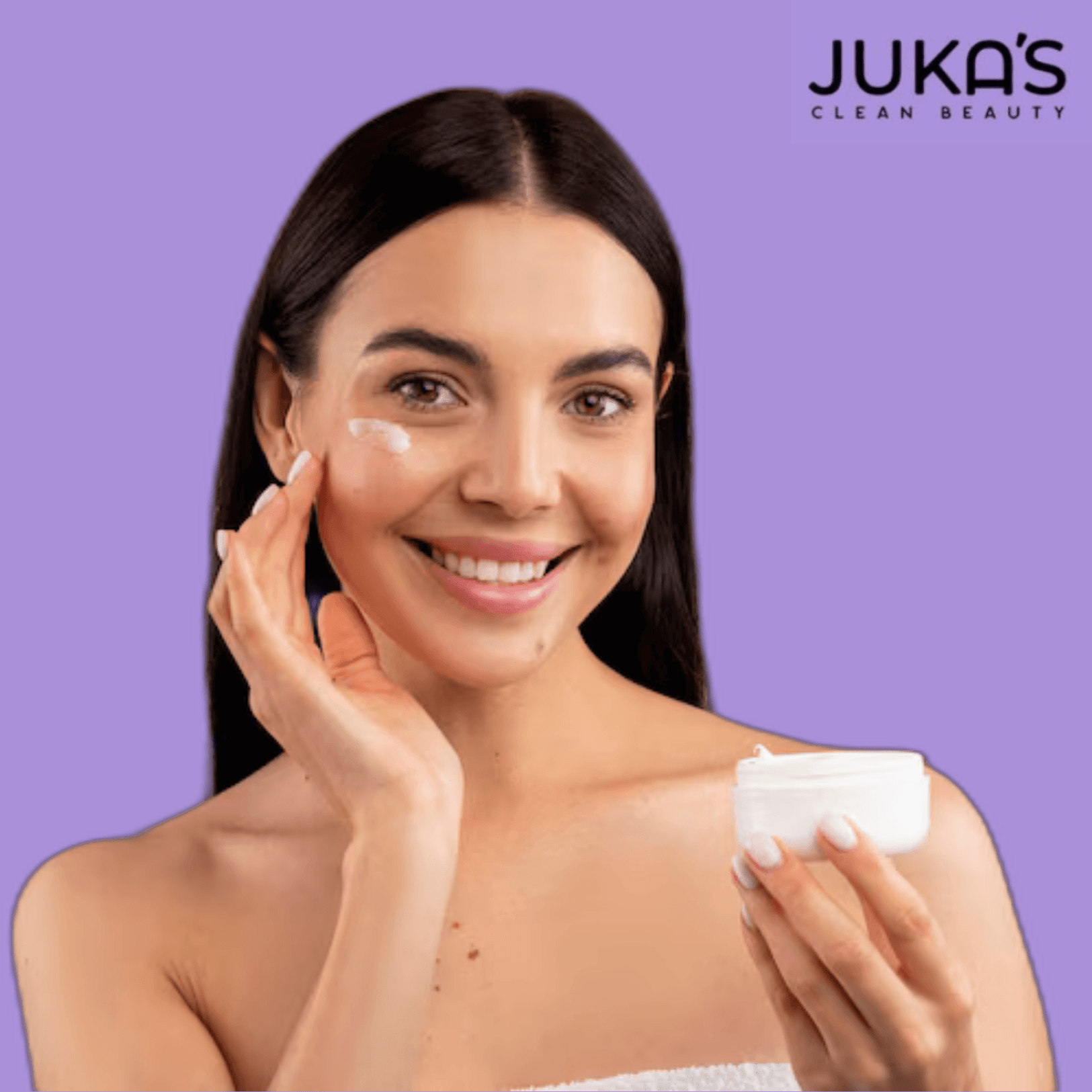 Woman applying Juka's vegan & plant-based facial mask for glowing skin.