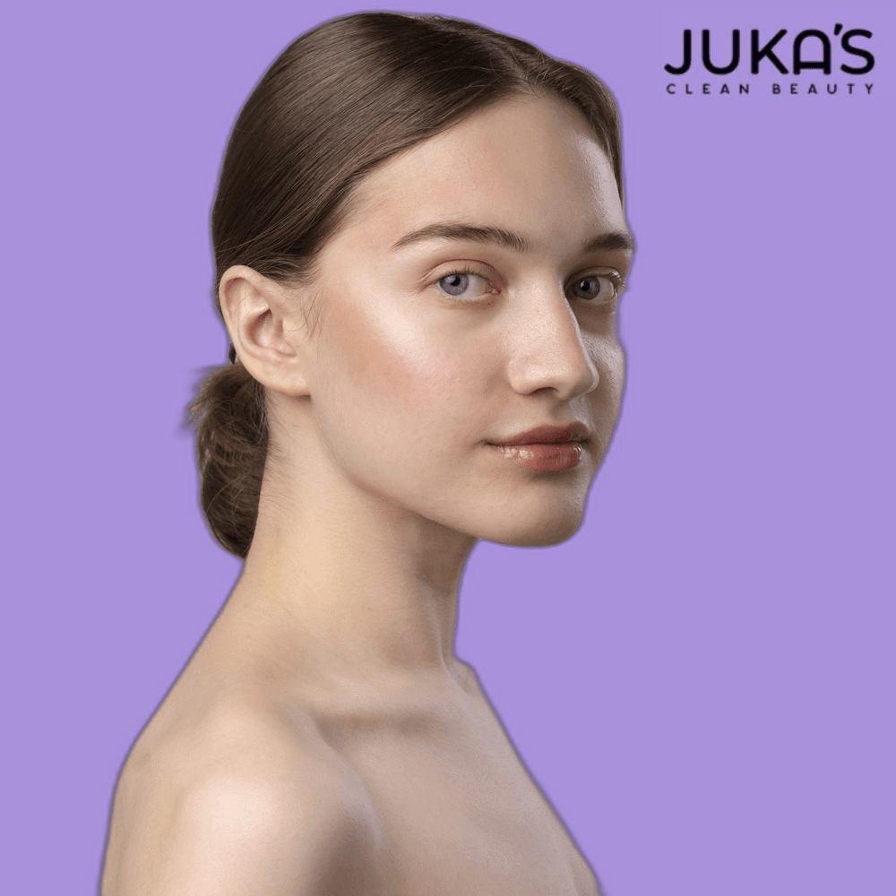 Woman showcasing Juka's clean beauty hyperpigmentation moisturizer with radiant skin on a purple background.