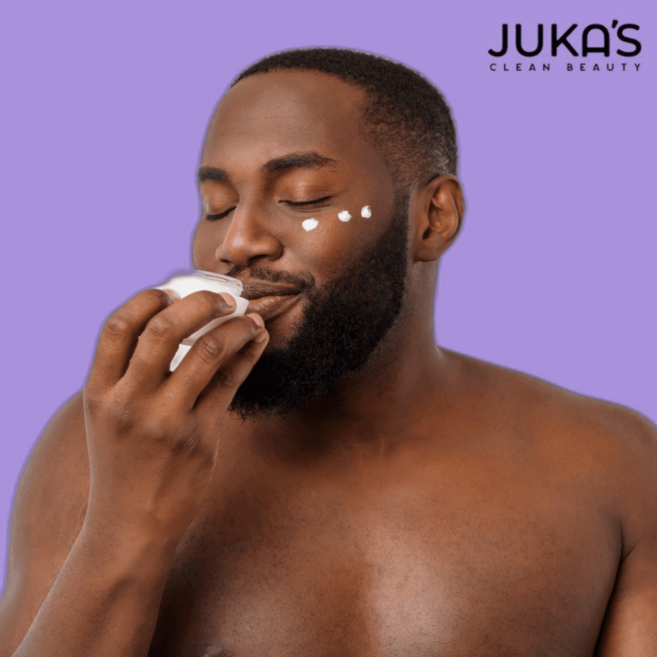 Man applying Juka's clean beauty products in your skincare routine on his face with a smile.