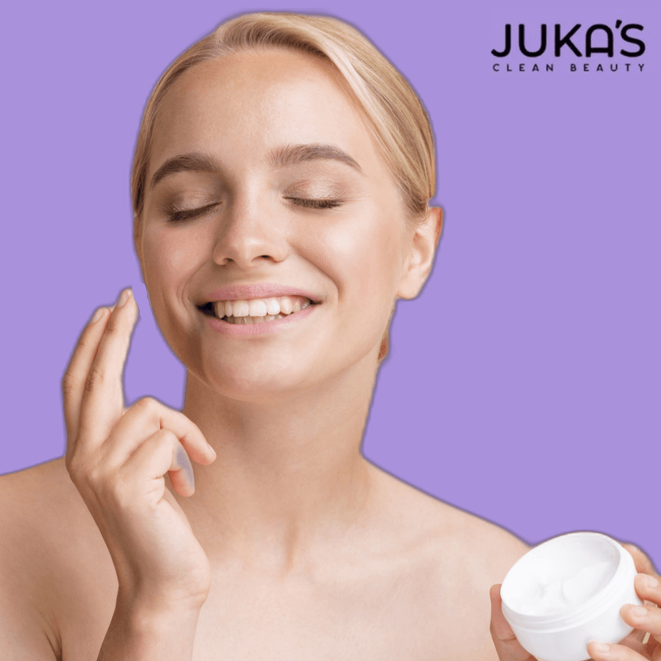 Woman applying Juka's Clean Beauty vegan skincare essentials for a natural look.