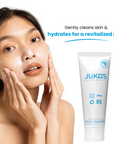 Woman using JUKA'S Daily Facial Cleanser on her face